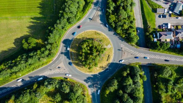 Aerial long exposure of traffic on a roundabout in a small town