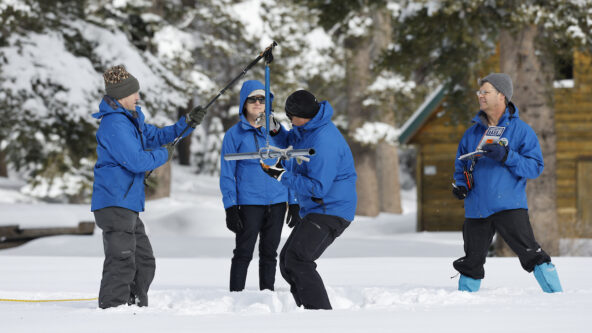 photo four California Department of Water Resources staff at Phillips Station take a manual snow survey on January 3, 2023 | source California DWR