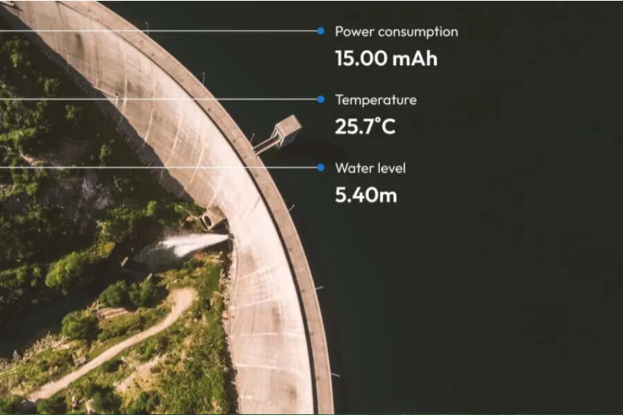 aerial photo of a portion of a dam; camera angle gives the dam a curved appearance; data callouts for monitoring device 