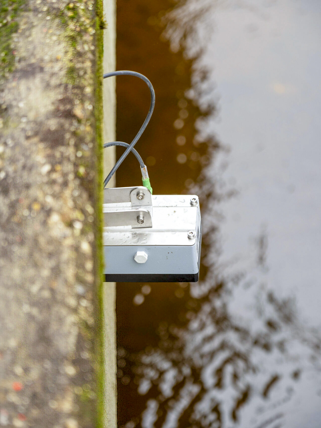 photo of HyQuant non-contact radar sensor mounted on a stone bridge in Duisburg to measure water level and water velocity