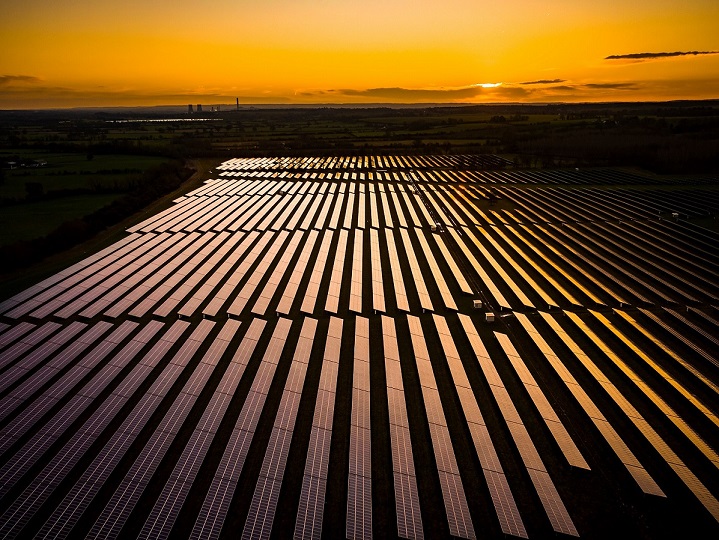 panoramic and aerial photo over a solar project at sunrise in English countryside | AdobeStock_253259538