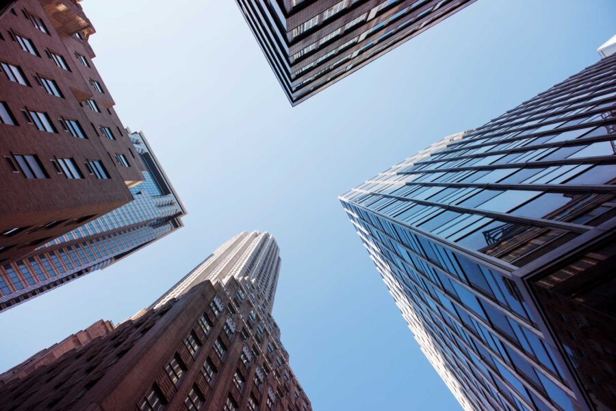 up-angle photograph at intersection of four skyscrapers to denote building management and building maintenance | source AdobeStock_413774970