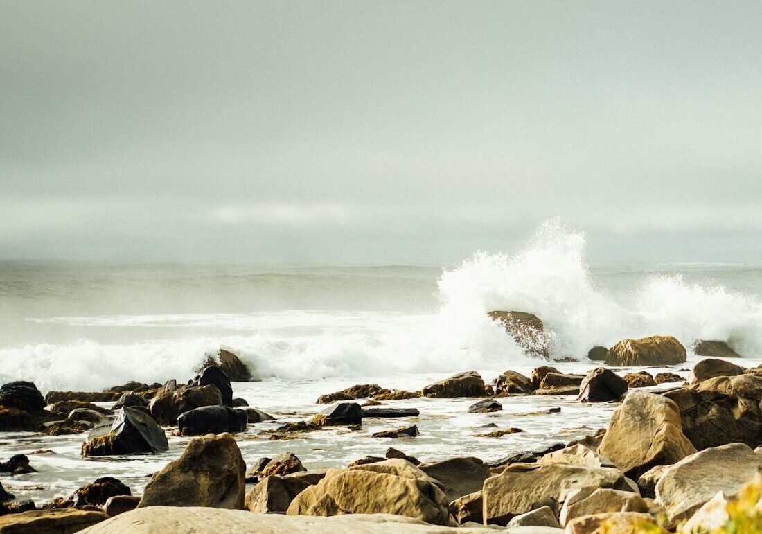 photo of Atlantic Ocean waves crashing on rocks at White Point, Nova Scotia, Canada during the daytime | credit Tim Foster via unsplash